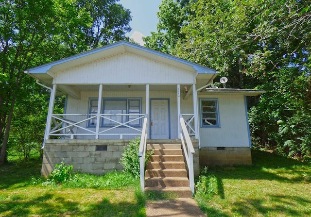 110 E First St, Hardy, AR 72542 - bungalow featuring crawl space, covered porch, and a front lawn