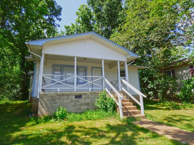 110 E First St, Hardy, AR 72542 - view of front facade with a front lawn and a porch