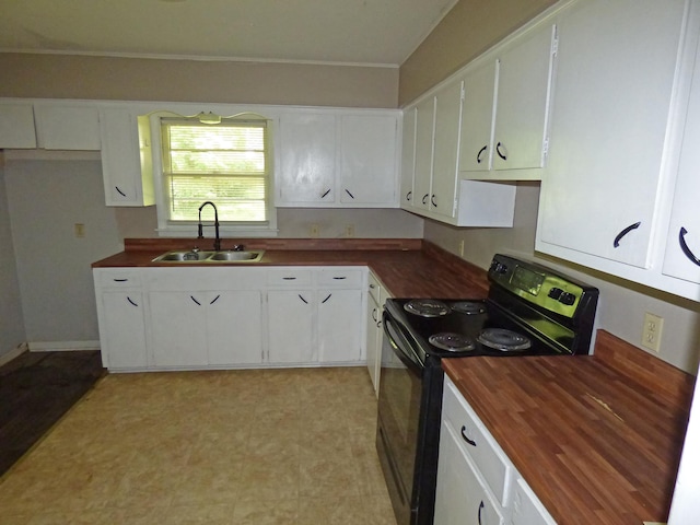 110 E First St, Hardy, AR 72542 - kitchen with black electric range, butcher block counters, and white cabinets