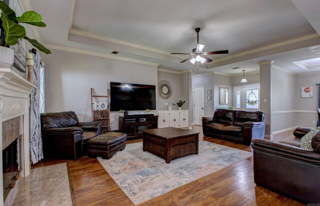 4600 Lexington Park Cir, Bryant, AR 72022 - living area with a premium fireplace, wood finished floors, ceiling fan, a raised ceiling, and ornamental molding
