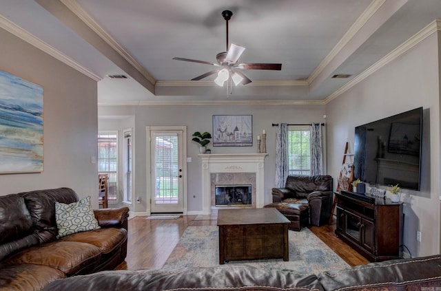 4600 Lexington Park Cir, Bryant, AR 72022 - living area with wood finished floors, a premium fireplace, ceiling fan, a tray ceiling, and ornamental molding