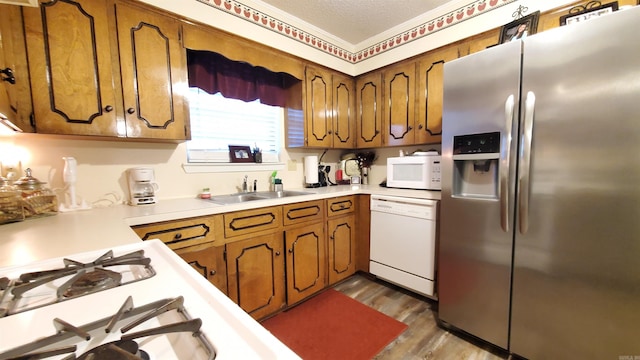81 Pheasant Run Dr, Cabot, AR 72023 - kitchen with white appliances, light countertops, brown cabinets, and wood finished floors