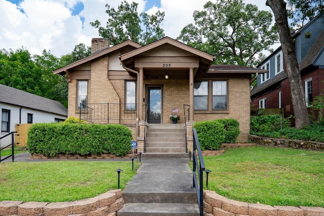 205 S Martin St, Little Rock, AR 72205 - view of front of property featuring a chimney, brick siding, and a front yard