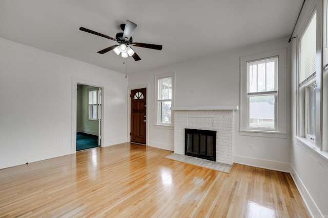 205 S Martin St, Little Rock, AR 72205 - unfurnished living room featuring wood finished floors, ceiling fan, and a fireplace
