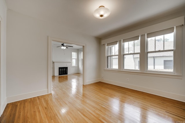 205 S Martin St, Little Rock, AR 72205 - unfurnished room with a ceiling fan, light wood-style flooring, and a brick fireplace