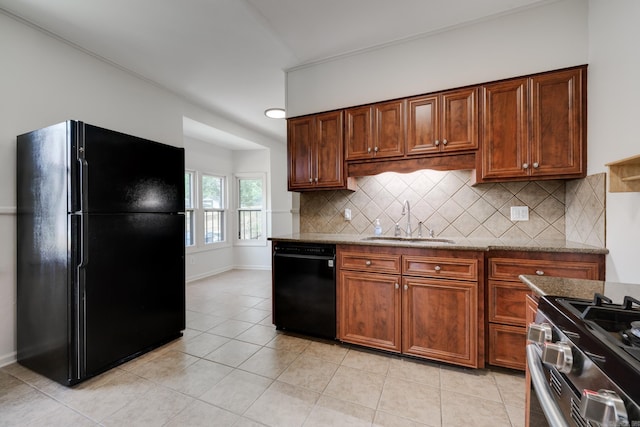 205 S Martin St, Little Rock, AR 72205 - kitchen with black appliances, tasteful backsplash, light tile patterned floors, and light stone counters