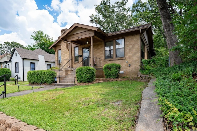 205 S Martin St, Little Rock, AR 72205 - bungalow featuring brick siding, a chimney, and a front yard