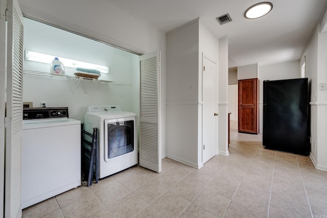 205 S Martin St, Little Rock, AR 72205 - laundry area with washing machine and dryer, light tile patterned floors, and crown molding