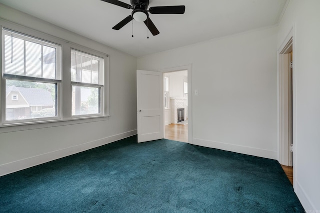 205 S Martin St, Little Rock, AR 72205 - unfurnished bedroom with dark colored carpet and ceiling fan