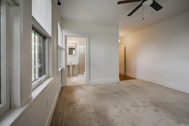 205 S Martin St, Little Rock, AR 72205 - unfurnished bedroom with multiple windows, carpet, ensuite bathroom, and a ceiling fan
