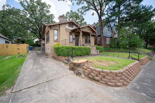 205 S Martin St, Little Rock, AR 72205 - view of front facade with a gate, brick siding, a chimney, and concrete driveway