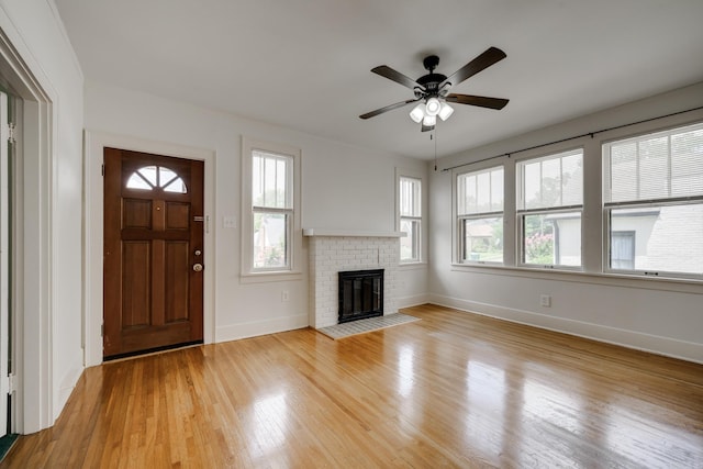 205 S Martin St, Little Rock, AR 72205 - unfurnished living room with light wood finished floors, a fireplace, and a ceiling fan