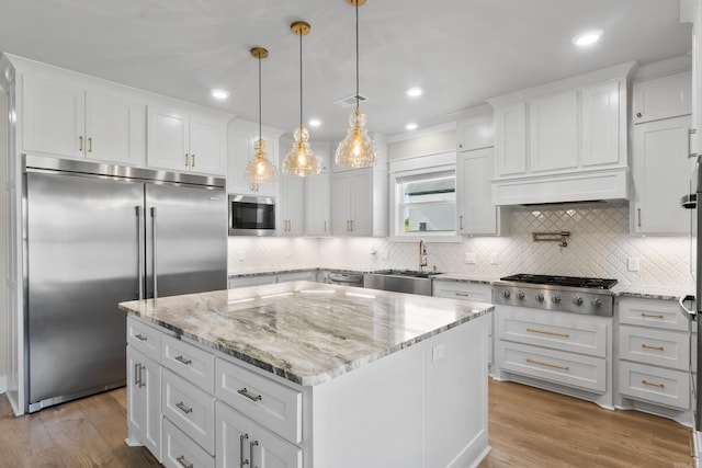 148 Irene Cir, Greenbrier, AR 72058 - kitchen featuring built in appliances, a center island, tasteful backsplash, white cabinetry, and wood finished floors