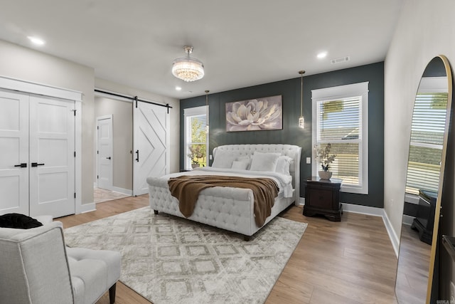 148 Irene Cir, Greenbrier, AR 72058 - bedroom with a barn door, light wood finished floors, and recessed lighting