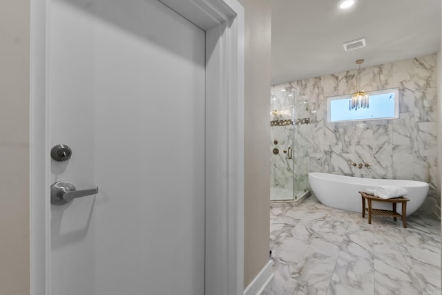 148 Irene Cir, Greenbrier, AR 72058 - bathroom featuring marble look tile flooring, a marble finish shower, and a freestanding tub