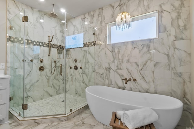 148 Irene Cir, Greenbrier, AR 72058 - full bathroom featuring a marble finish shower, a soaking tub, a chandelier, marble tiled floors, and tile walls