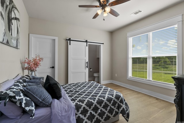 148 Irene Cir, Greenbrier, AR 72058 - bedroom featuring a barn door, light wood-style floors, and ceiling fan