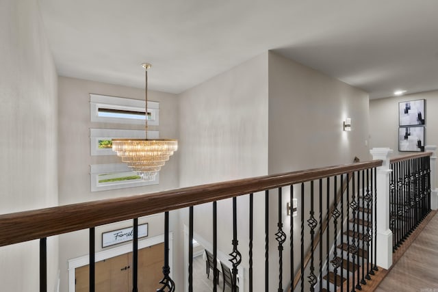 148 Irene Cir, Greenbrier, AR 72058 - hallway featuring a chandelier, an upstairs landing, and wood finished floors