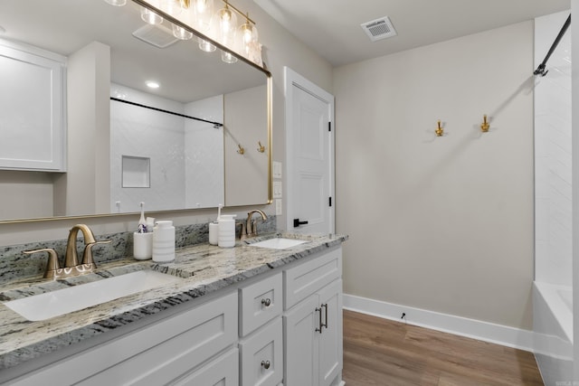 148 Irene Cir, Greenbrier, AR 72058 - full bath featuring double vanity, wood finished floors, and shower / washtub combination