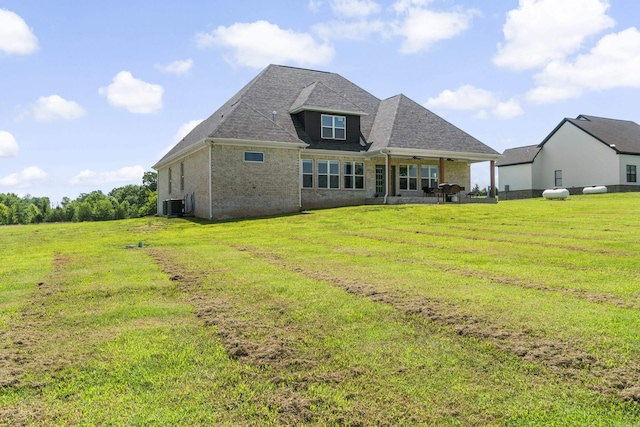 148 Irene Cir, Greenbrier, AR 72058 - back of property with brick siding, a lawn, and roof with shingles