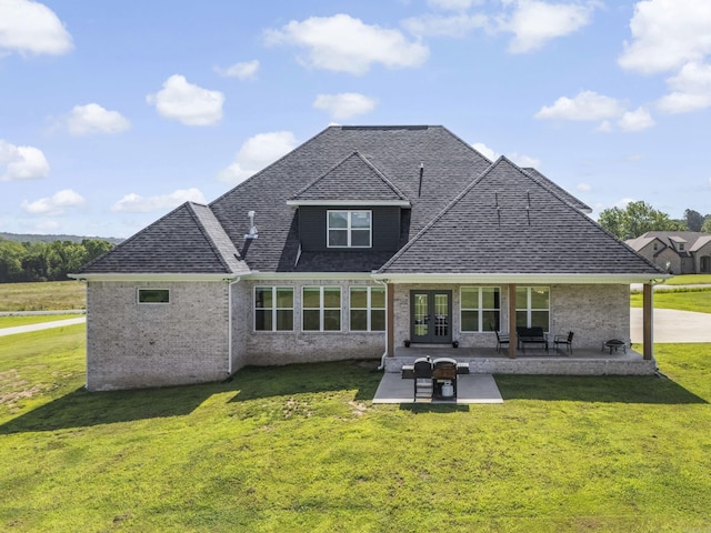 148 Irene Cir, Greenbrier, AR 72058 - back of property featuring french doors, a lawn, brick siding, and a patio