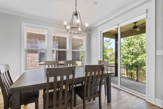 49 Saffron Cir, Little Rock, AR 72223 - dining room with wood finished floors, a chandelier, and crown molding