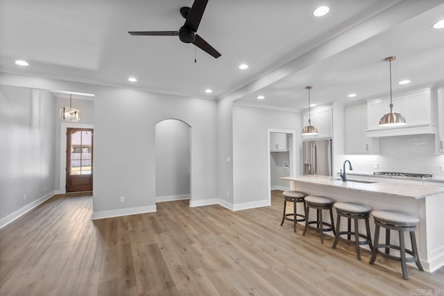 49 Saffron Cir, Little Rock, AR 72223 - living area featuring ceiling fan, light wood-style flooring, recessed lighting, arched walkways, and ornamental molding