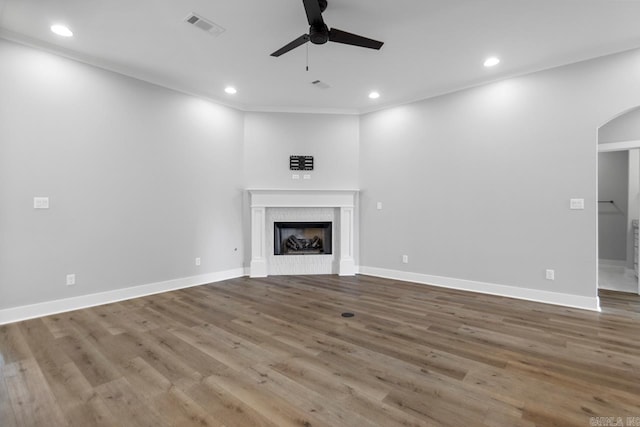49 Saffron Cir, Little Rock, AR 72223 - unfurnished living room with a ceiling fan, arched walkways, recessed lighting, wood finished floors, and a fireplace
