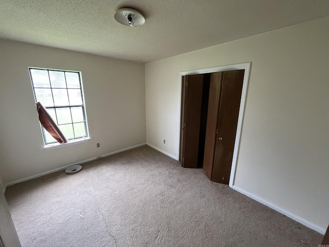 9313 Timber Valley Rd, Little Rock, AR 72204 - unfurnished bedroom with carpet, a textured ceiling, and a closet