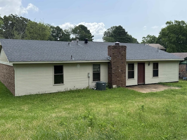9313 Timber Valley Rd, Little Rock, AR 72204 - back of property with a lawn, roof with shingles, a chimney, and a patio area