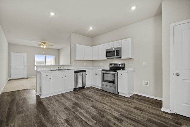 116 Baldwin Dr, Beebe, AR 72012 - kitchen with stainless steel appliances, light countertops, dark wood-type flooring, white cabinets, and a peninsula
