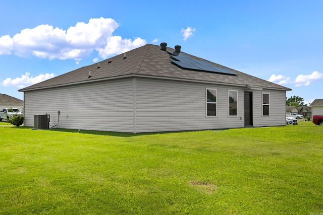116 Baldwin Dr, Beebe, AR 72012 - back of house featuring solar panels, a lawn, and a shingled roof