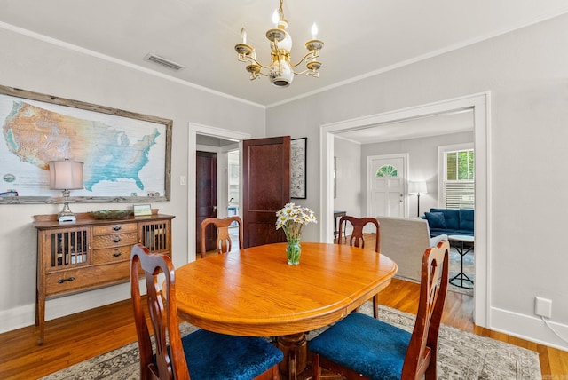 127 W F Ave, North Little Rock, AR 72116 - dining area featuring wood finished floors, a chandelier, and crown molding