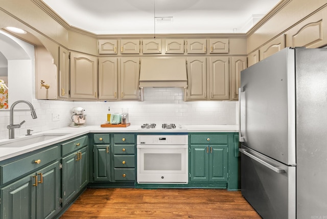 127 W F Ave, North Little Rock, AR 72116 - kitchen with white appliances, custom exhaust hood, backsplash, and light countertops