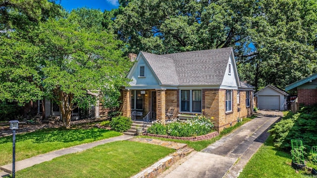 127 W F Ave, North Little Rock, AR 72116 - view of front of house with an outdoor structure, brick siding, a garage, a front lawn, and asphalt driveway