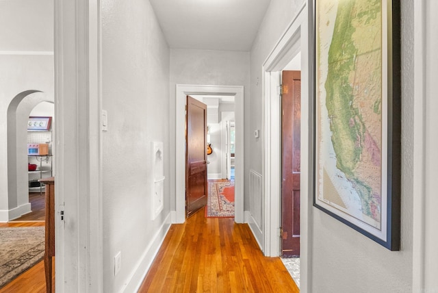 127 W F Ave, North Little Rock, AR 72116 - hallway featuring arched walkways and light wood-style floors