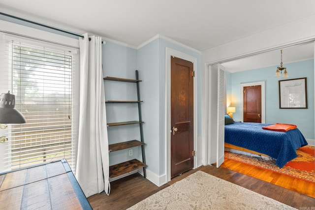 127 W F Ave, North Little Rock, AR 72116 - bedroom with wood finished floors, ornamental molding, and a closet