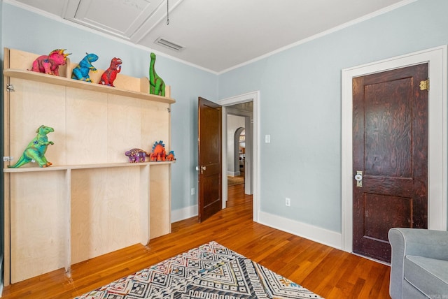 127 W F Ave, North Little Rock, AR 72116 - bedroom featuring wood finished floors, crown molding, and arched walkways