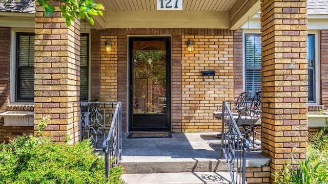 127 W F Ave, North Little Rock, AR 72116 - property entrance featuring covered porch and brick siding