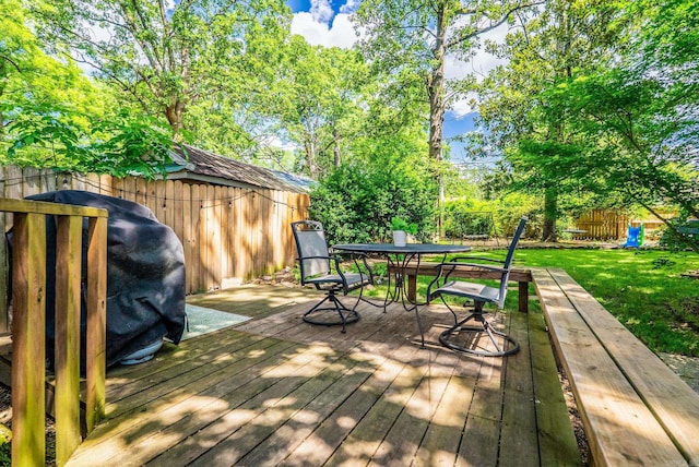 127 W F Ave, North Little Rock, AR 72116 - wooden terrace featuring outdoor dining space, a fenced backyard, and area for grilling