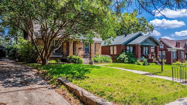 127 W F Ave, North Little Rock, AR 72116 - view of front of home with brick siding and a front lawn
