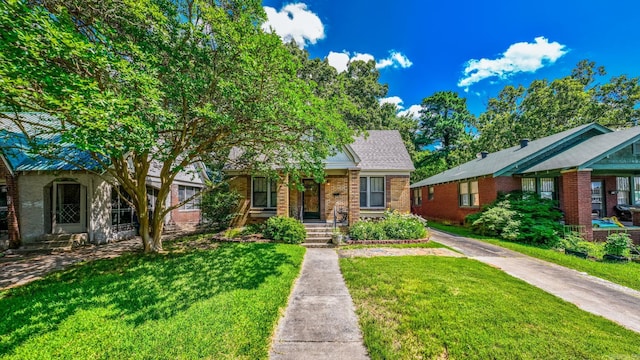 127 W F Ave, North Little Rock, AR 72116 - view of front facade featuring brick siding and a front lawn
