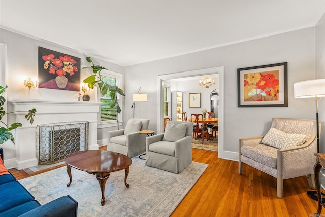 127 W F Ave, North Little Rock, AR 72116 - living room featuring a chandelier, wood finished floors, and a fireplace with flush hearth