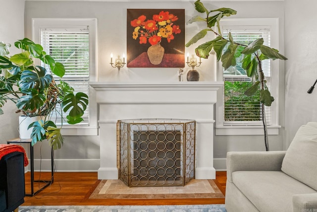 127 W F Ave, North Little Rock, AR 72116 - living area with a fireplace with raised hearth and wood finished floors