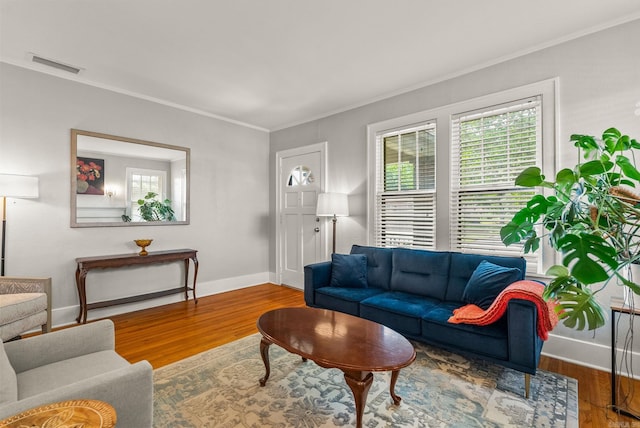 127 W F Ave, North Little Rock, AR 72116 - living room with healthy amount of natural light, ornamental molding, and wood finished floors