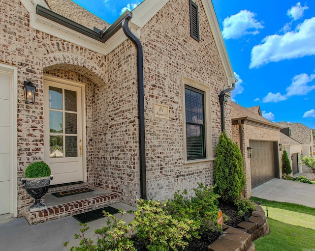 101 Mergeron Ct, Little Rock, AR 72212 - entrance to property with an attached garage, driveway, and brick siding