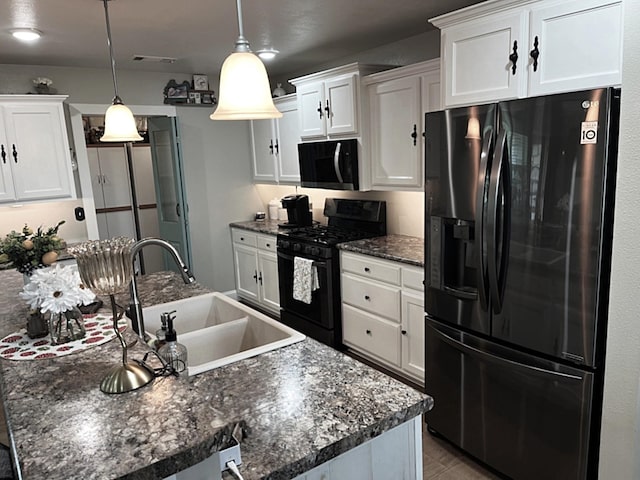 758 Barren Fork Rd, Mount Pleasant, AR 72561 - kitchen featuring fridge with ice dispenser, black gas range oven, white cabinets, and a kitchen island with sink