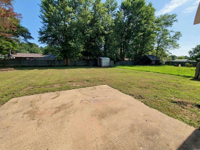 18 Langford St, Ward, AR 72176 - fenced backyard with a storage unit and a patio