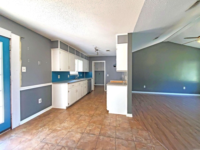 18 Langford St, Ward, AR 72176 - kitchen featuring white cabinets, a textured ceiling, a ceiling fan, dishwasher, and light countertops