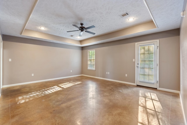 970 Wineberry, Conway, AR 72034 - empty room featuring a tray ceiling, a textured ceiling, a ceiling fan, and concrete floors